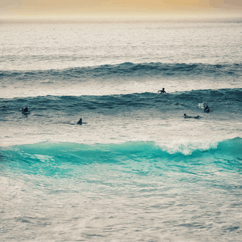 Learn to surf to beginner-friendly waves at Polzeath Beach, a five-minute drive away