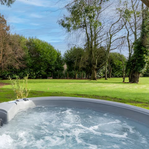 Enjoy serene garden views while relaxing in the hot tub