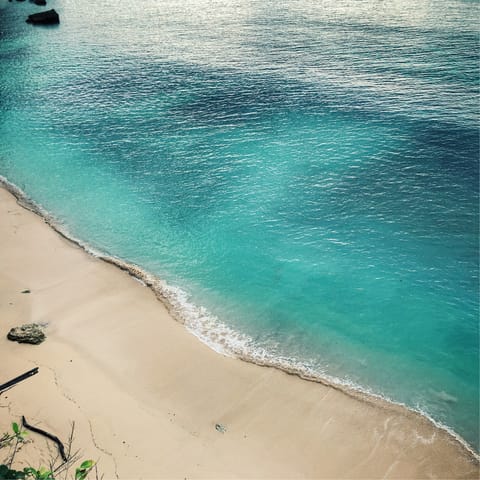 Swim the turquoise waters off Batu Bolong, a short drive away