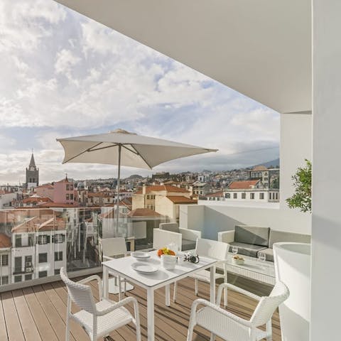 Watch the sun rise over Funchal from your private balcony