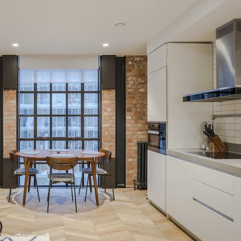 Cook up something tasty in the modern kitchen and enjoy next to the full-length window