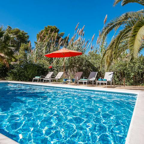 Cool off in the outdoor pool before relaxing on a sun lounger