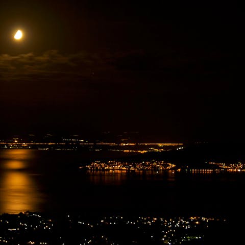 Watch the lights of nearby Pagasitikos Bay flicker on