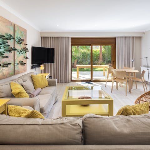 Relax in the open-plan living area  with its sunny yellow furnishings