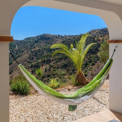 Relax in the hammock as you admire the breathtaking view of the mountains