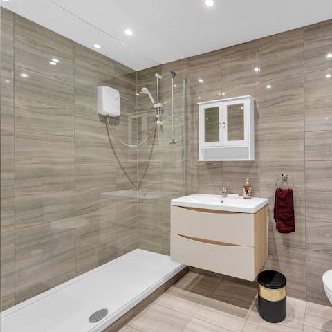 Get ready for an evening out in the modern bathroom with its large shower