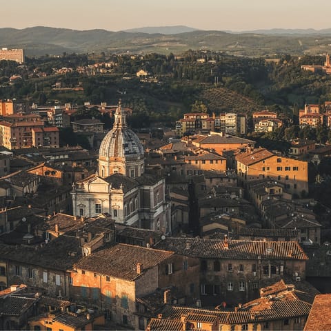 Spend a day strolling the historic streets of Siena – a short drive away
