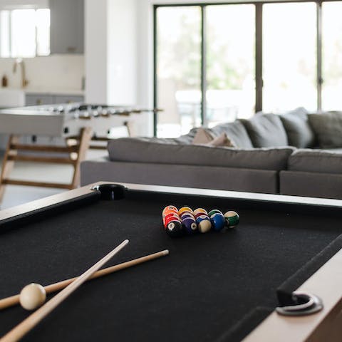 Play a game of pool in the living room