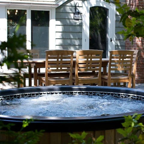 Sink into the hot tub and enjoy a glass of wine as you relax