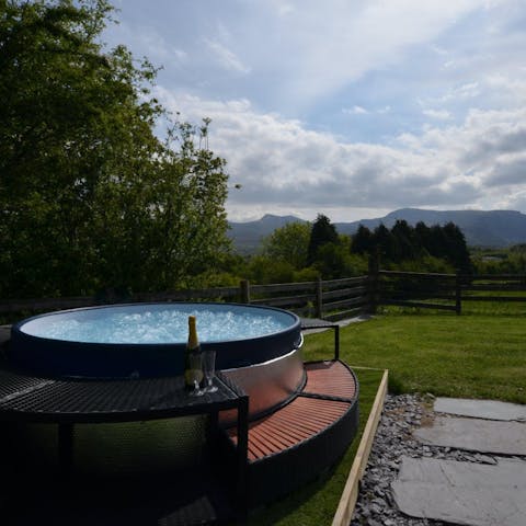 Soak in the hot tub while taking in the stunning views of Snowdonia