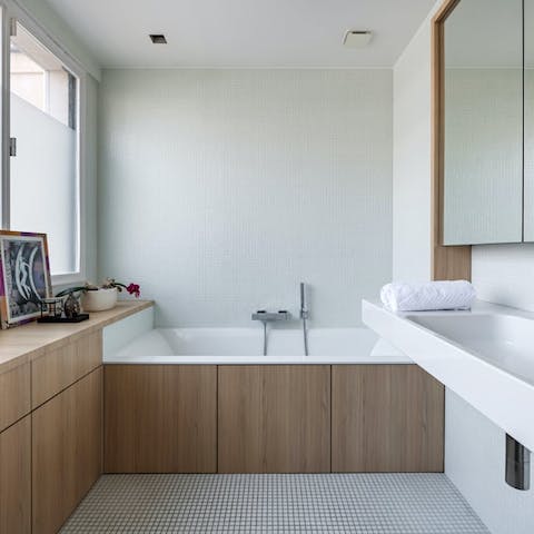 Treat yourself to a relaxing soak in the sleek bathtub
