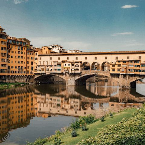 Cross the historic Ponte Vecchio, a one-minute walk away