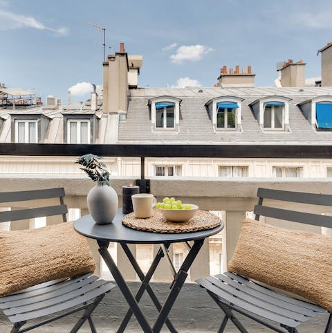 Take in the views over the Parisian rooftops from the private balcony