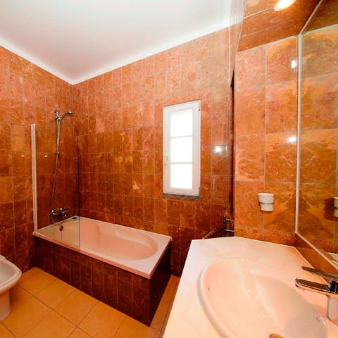 Treat yourself to a long and indulgent soak in the sleek bathtub