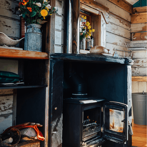 Cosy up next to the log burner in the wood cabin