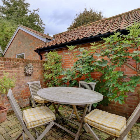 Take your breakfast out to the charming walled patio