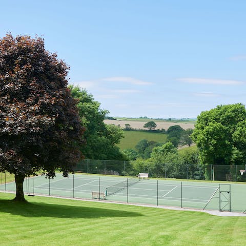 Practise your serve in the sunshine on the tennis court