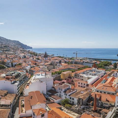 Stay in the heart of Funchal where the orange-roofed buildings leads to the sea
