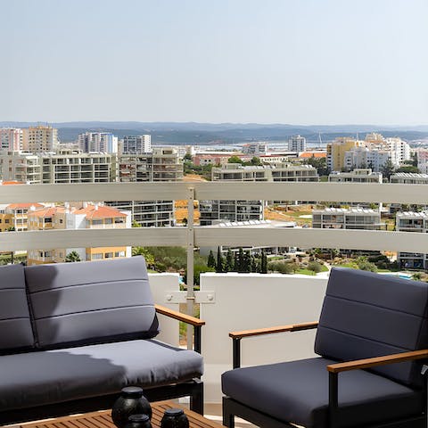 Admire the views over the town and the hills in the distance from the balcony