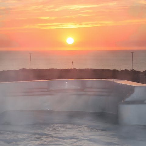 Enjoy a relaxing soak in the hot tub as the sunsets over the ocean