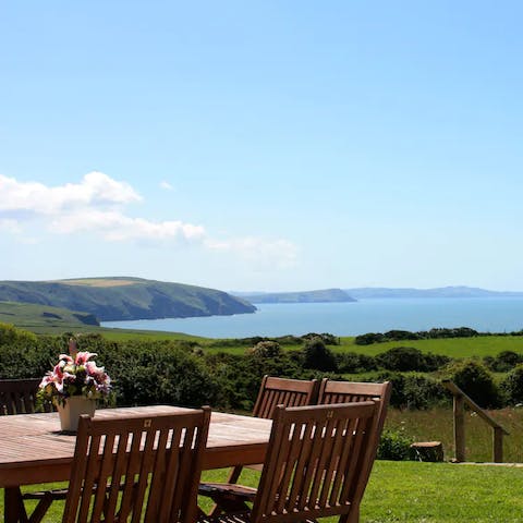 Share a bottle of wine in the sunshine, admiring the views of Ceibwr Bay