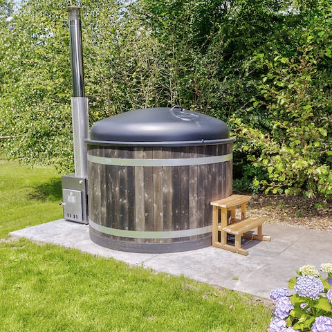 Enjoy a long, relaxing soak in the private wood-fired hot tub