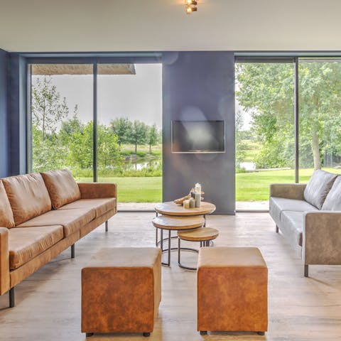 Relax on the leather sofas with views of the water