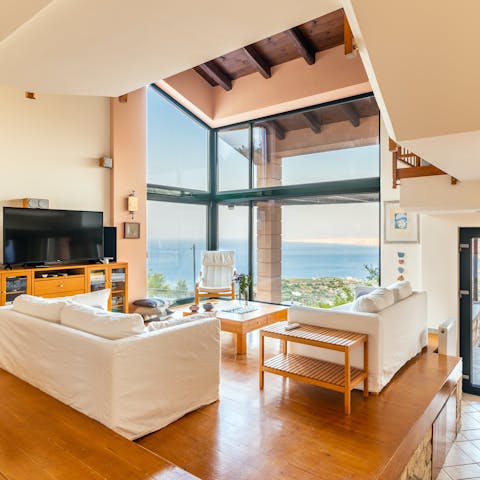 Enjoy an endless sea view from a wall of glass in the living room