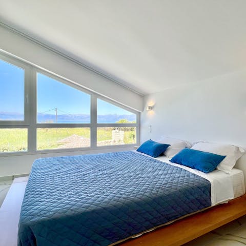 Wake up to picturesque views of the Ionian sea right outside your bedroom window