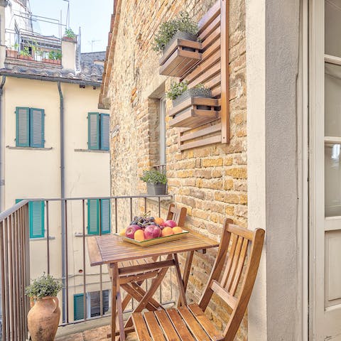 Enjoy a glass of Italian wine on the private balcony