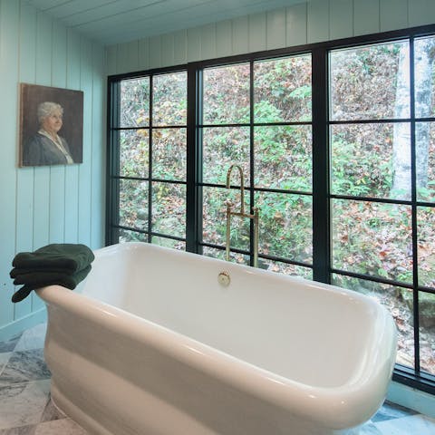 Soak in the oversized tub with scenic views of woodland