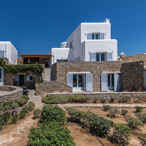 Find a quiet spot among the Mediterranean vegetation in the villa's outdoor space