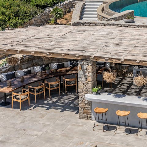 Work culinary magic in the well-equipped outdoor kitchen and serve under the pergola