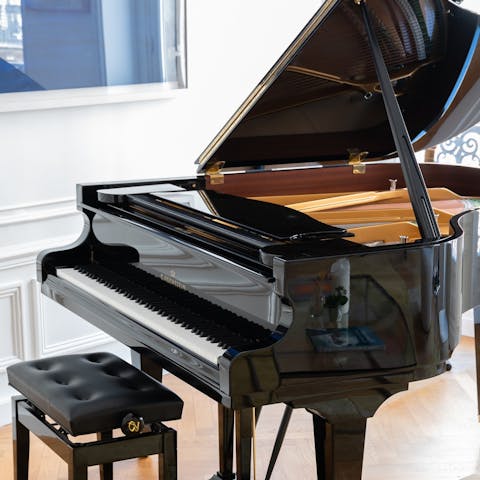 Tickle the ivories of the grand piano in the living area