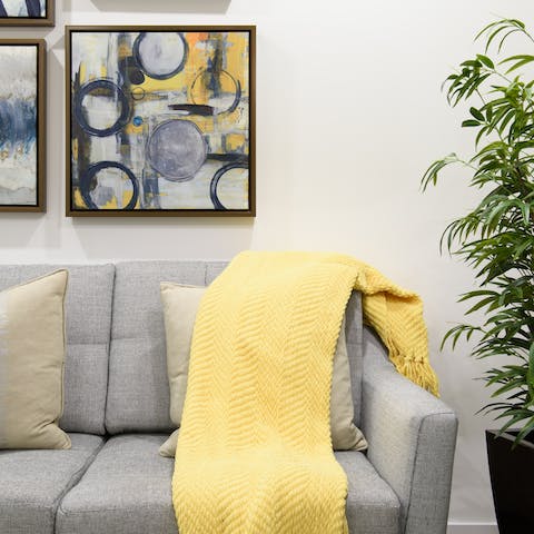 Get cosy on the sofa beneath striking modern artworks