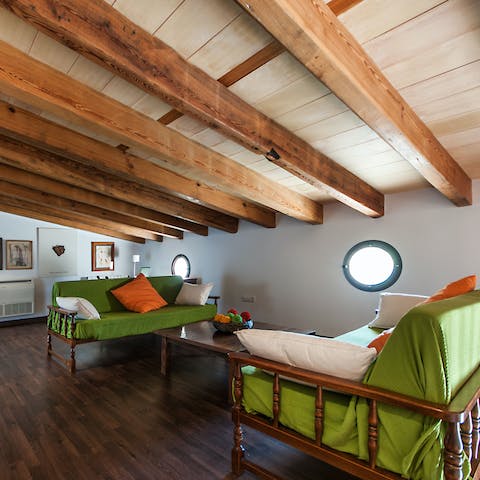 Curl up with a good book in this cosy reading nook under the exposed beams