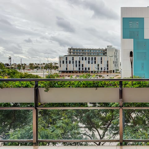 Sip your morning coffee on the balcony while looking out over the modern buildings 