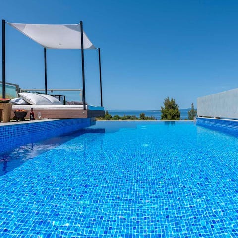 Relax in the Greek sun by your private, infinity pool