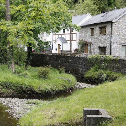 Stay in a converted water mill overlooking a stream