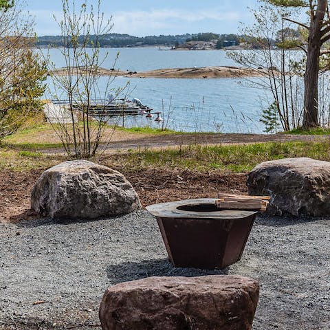 Enjoy the warmth of the fire pit with views over the ocean