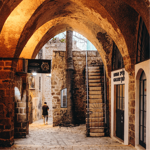 Explore Old Jaffa and its winding alleys filled with craft shops and art galleries, a thirteen-minute stroll away  