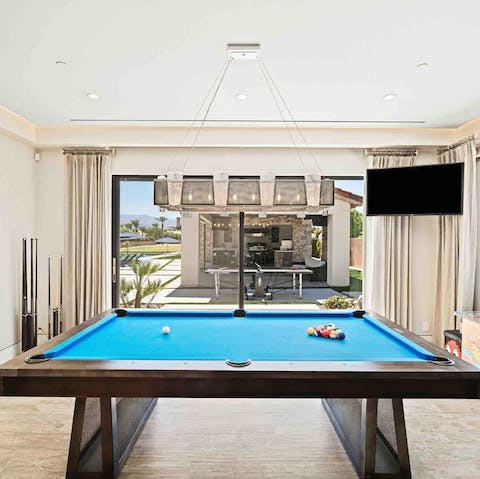 Unwind with a game of pool and a drink at your very own bar