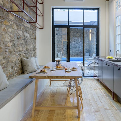 Enjoy a Greek meze in the kitchen with its exposed stone wall