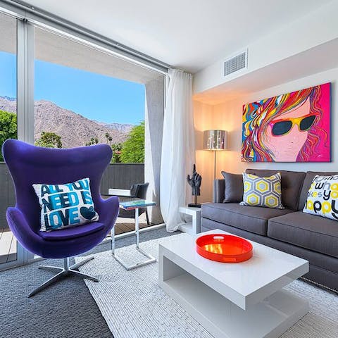 Relax in the colourful living space with its mountain vistas