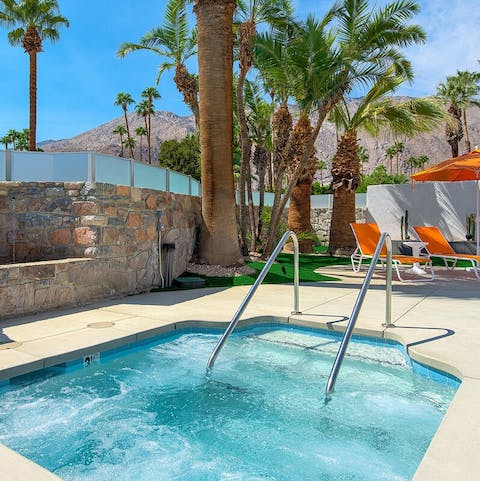 Unwind in the communal jacuzzi surrounded by palm trees