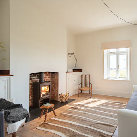 Get cosy on the sofa in front of the log burner, with a mug of something warm