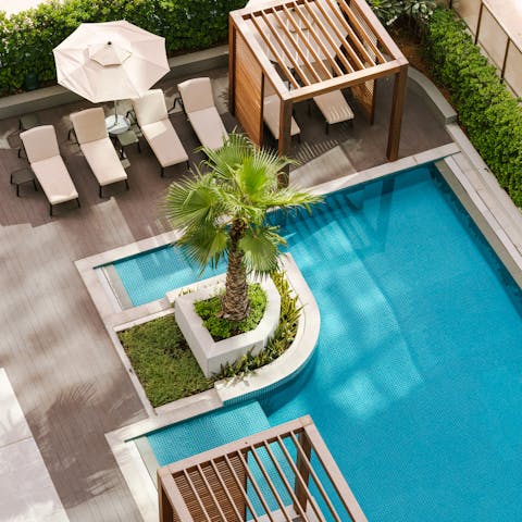 Splash about in the communal swimming pool before dozing off on a lounger