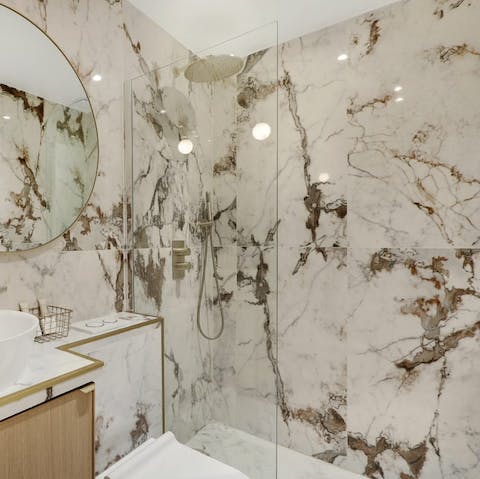 Start mornings with a relaxing soak under the marble bathroom's rainfall shower