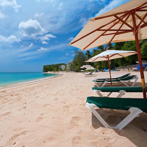 Enjoy private access to a dreamy sandy beach, with loungers and umbrellas provided by your host