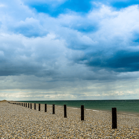 Go for a relaxing walk along Salthouse Beach, a ten-minute drive from home